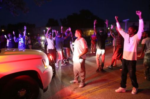 "Don't shoot me!" say protesters of Ferguson community to police officers.
