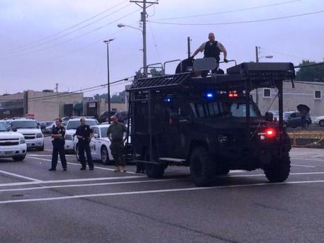 Up to 60 police units arrive in military SWAT vehicles, responding to a perceived threat from 100 peaceful protesters outraged at the police murder of 18 year-old Michael Brown